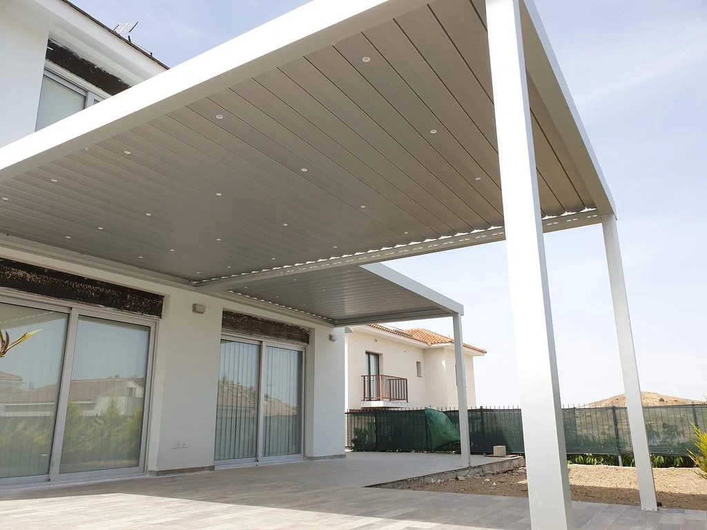Large white aluminium bioclimatic pergola installed by Protent Cyprus