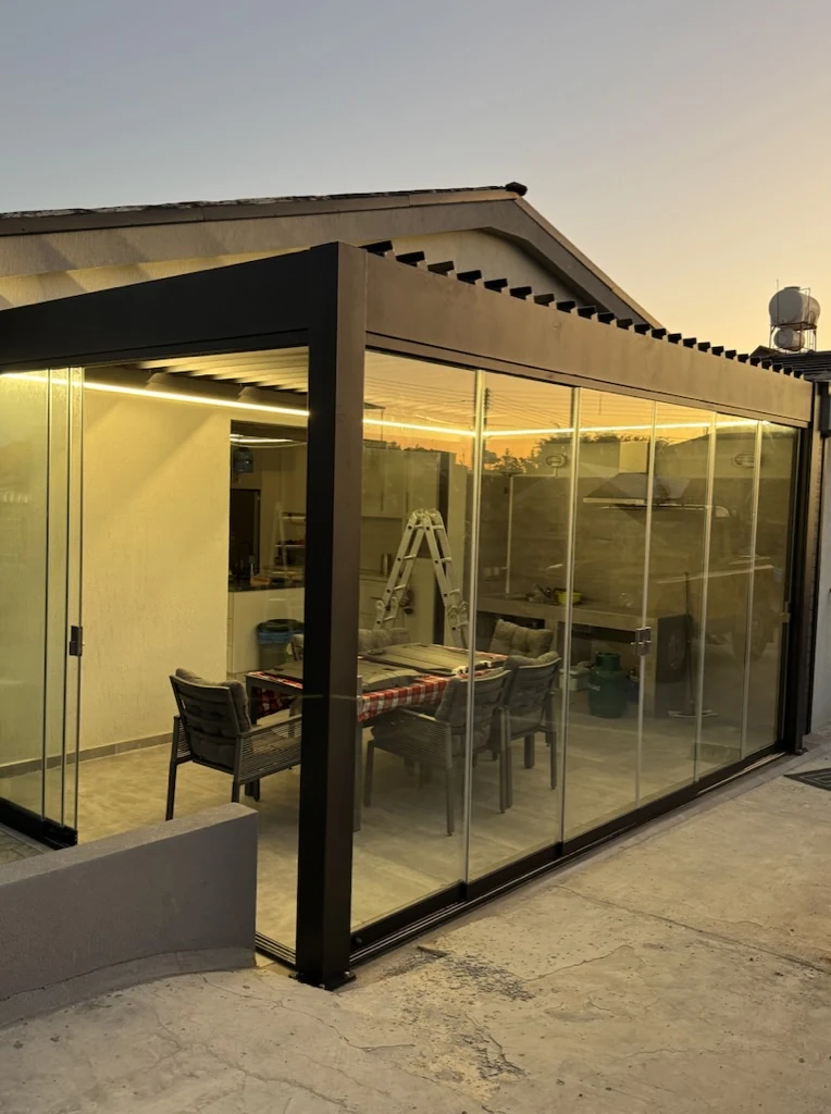Side perspective of dark aluminium bioclimatic pergola installation by Protent Cyprus